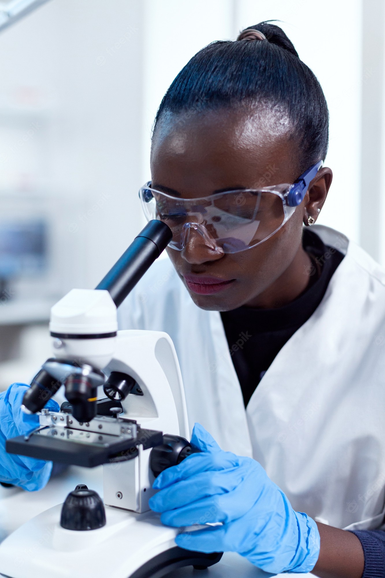 close-up-chemist-african-ethnicity-doing-sample-analysis-looking-through-microscope-black-healthcare-scientist-biochemistry-laboratory-wearing-sterile-equipment_482257-10813